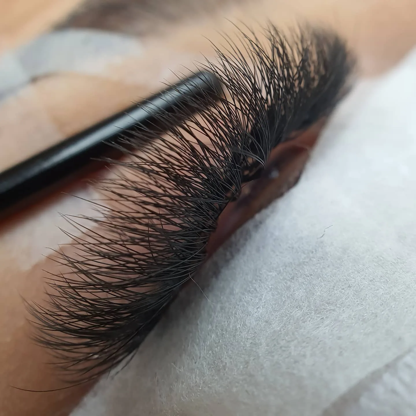 Lash extensions being applied